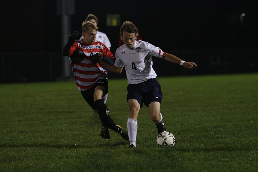 With the ball in his possession, senior Kyle Franklin attempts to push away the defender on Tuesday, Oct. 10. The team lost 3-4 to BVWest.