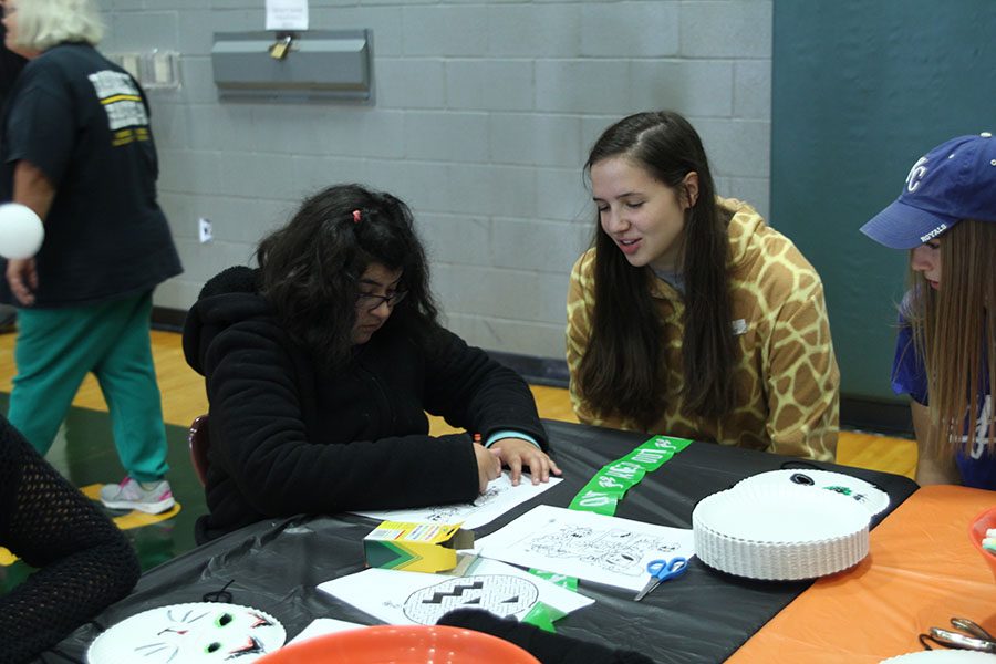 Junior Trinity Knapp compliments sophomore Alyssa Friass coloring.