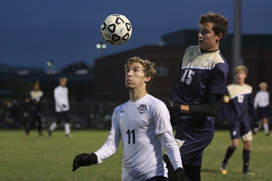 With the ball coming towards his head junior Jake Ashford looks directly to block it from an Aquinas player during the sub-state game on Tuesday Oct. 31.