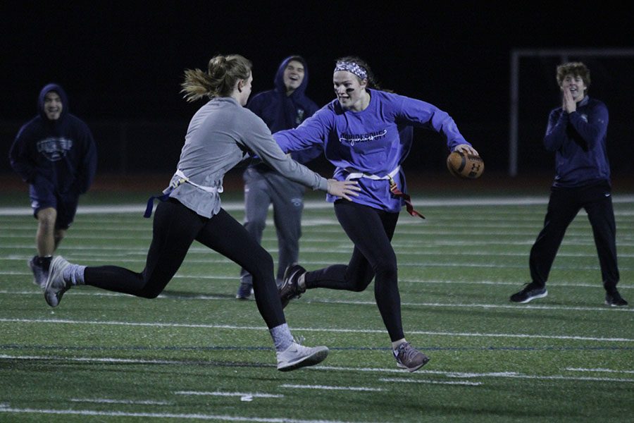 Avoiding the tackle, junior Claire Kaifes gets ready to throw the ball down field, resulting in the juniors win over the seniors on Monday, Nov. 6.