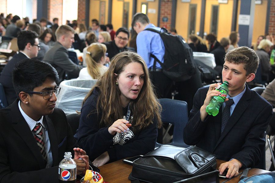 During the lunch break, debate coach Ann Goodson gives advice to sophomore Srikar Turaga and freshman Benjamin Wieland during their competition on Saturday, Nov. 4.