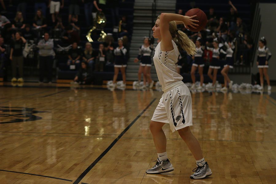 While executing a play, senior Adde Hinkle passes the ball to a teammate.