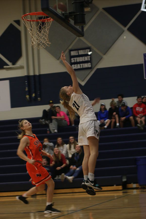 After beating her defender on a fast break, junior Lexi Ballard scores the layup.