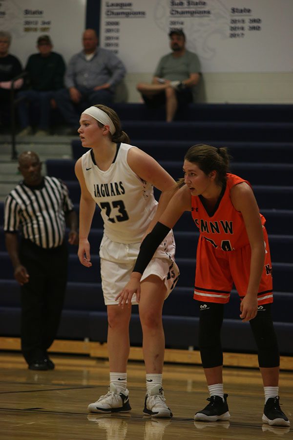 During the final minutes of the game, junior Claire Kaifes prepares to box out her opponent on a free throw.