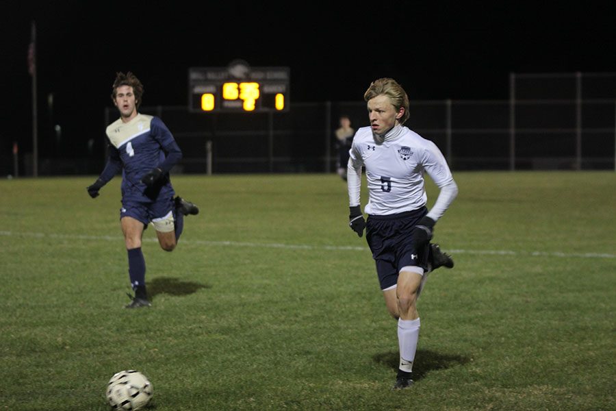 Sophomore Ian Carroll runs to take control of the ball during the second half of the game.