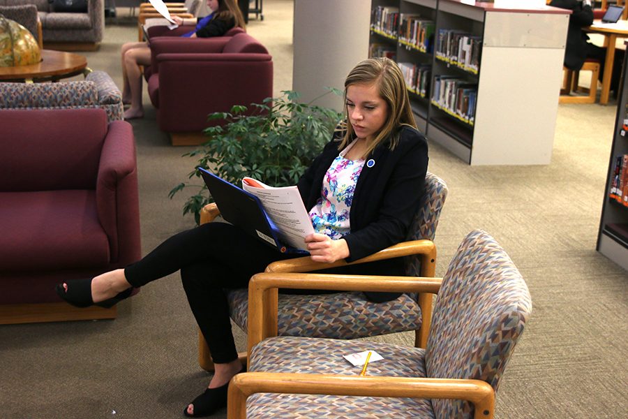 Looking at the test, junior Caroline Ratledge competes at the Leavenworth  High School DECA meet.  