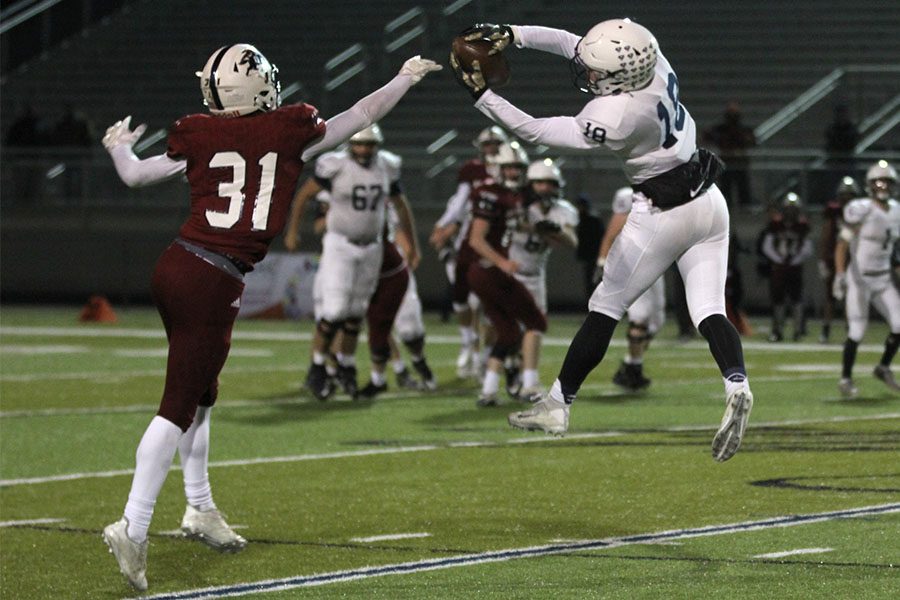 In their second match up of the season, the Jaguars beat the St. James Thunder 21-14 on Friday, Nov. 10. While keeping the ball away from a defender, senior Evan Rice catches a pass. 