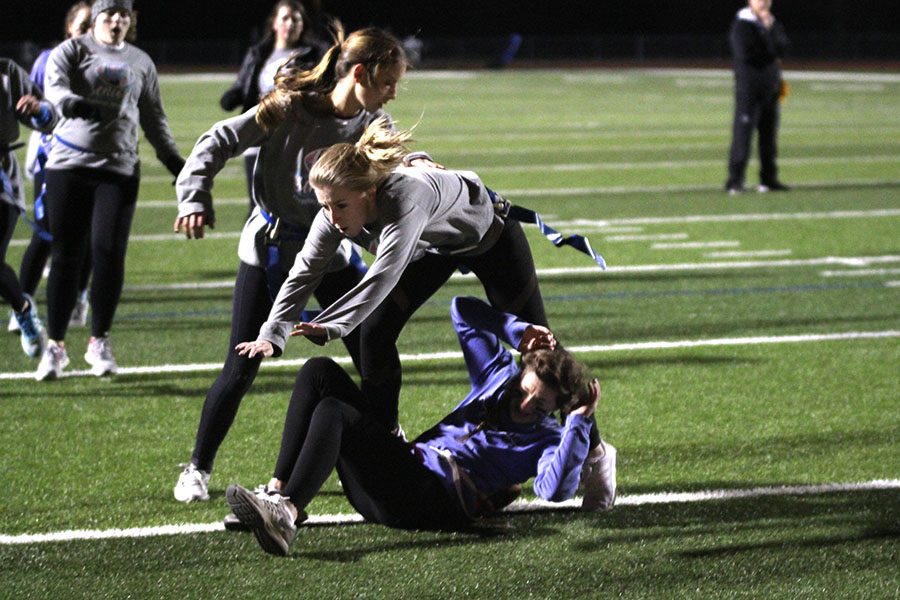 Following a rough play, senior Natalie Kalma jumps over a member of the opposing team.  Our defense was really strong, said Kalma, but our offense needed a lot of work.  I think it honestly came down to the fact that we didnt practice.