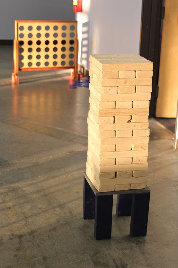 Large blocks of wood make up a larger form of the game Jenga where players have to pull out a block without causing the tower to fall.