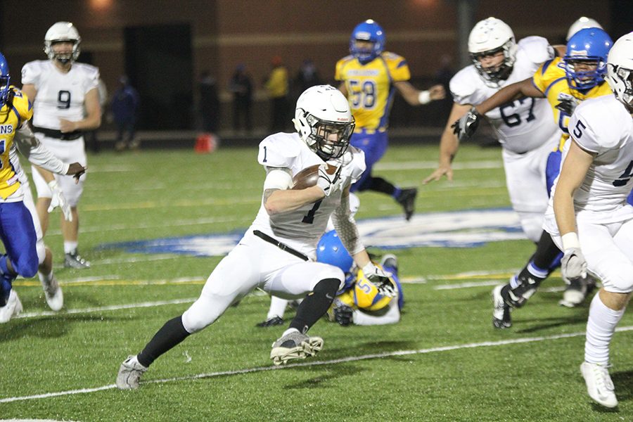 Cutting across to avoid members of the opposing team, junior Cameron Young runs upfield, resulting in a 57-12 win against Schlagle on Friday, Nov. 3. 