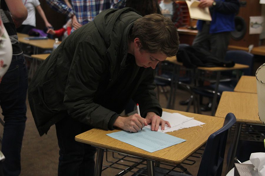 Once the match was over, caption Jameson Isaacsen signs the official score.