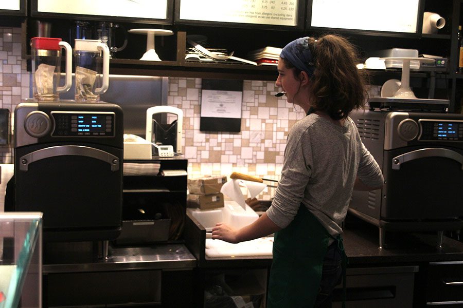 After taking a customers order, senior Whitney Burke prepares to cook a breakfast sandwich on Saturday, Nov. 18.