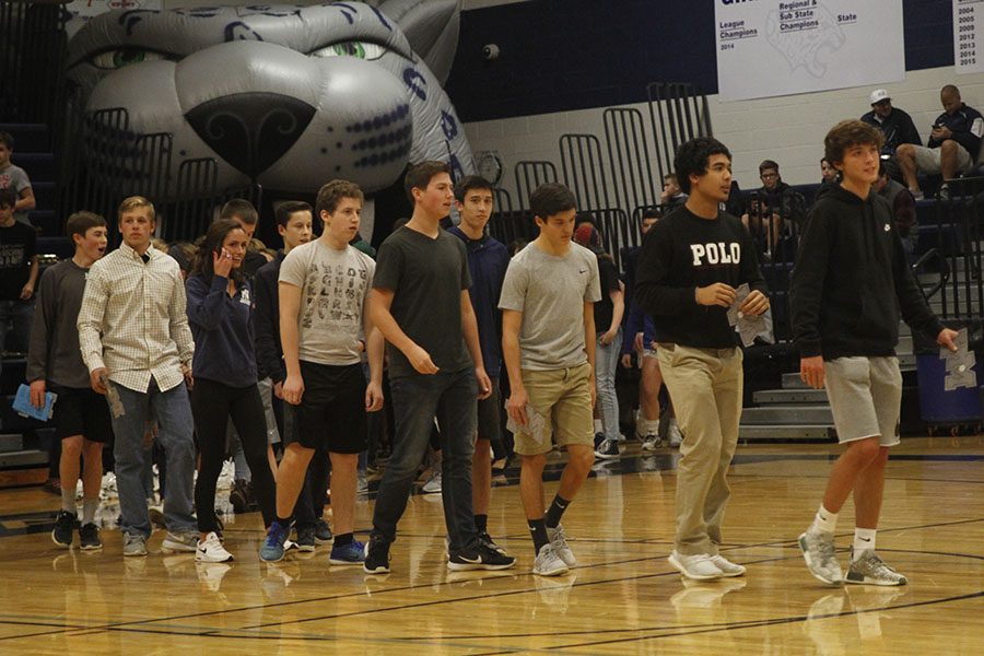 Lead by sophomore Anthony Pentola, a group of students walk out of the Jaguar head to be recognized at the academic letter ceremony on Friday, Dec. 1.  
