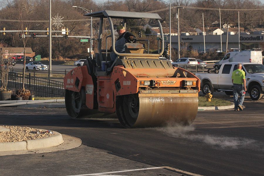 Operating the road roller, a construction worker paves the smoking asphalt on Friday, Dec. 1 in the Andy’s parking lot. The shop will have a drive-thru and outdoor seating. 