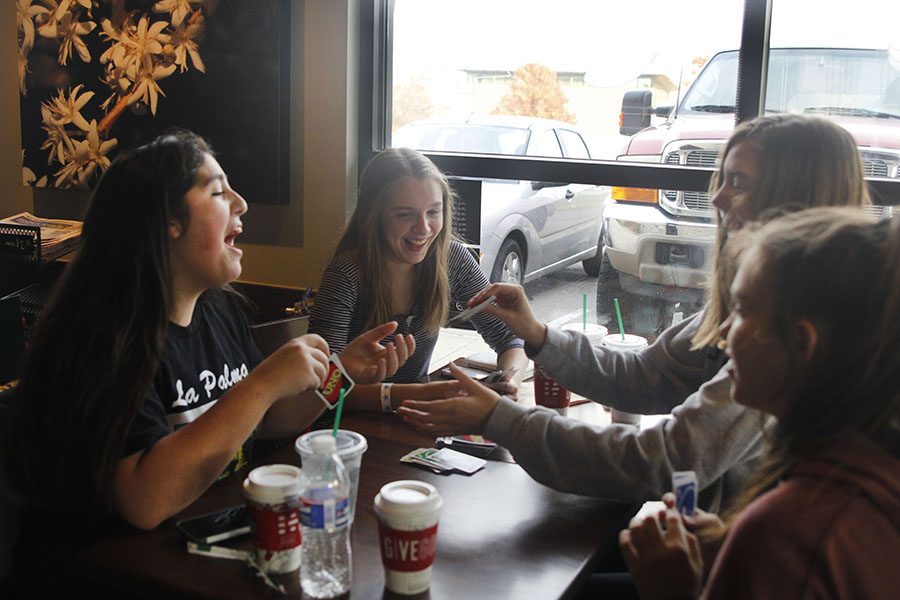 Participating in a weekly tradition, freshmen Aaliyah Gonzalez, Patty McClain, Claire Burke and Tatum Elliot drink coffee over a game of Uno at Starbucks on Friday, Nov. 17.