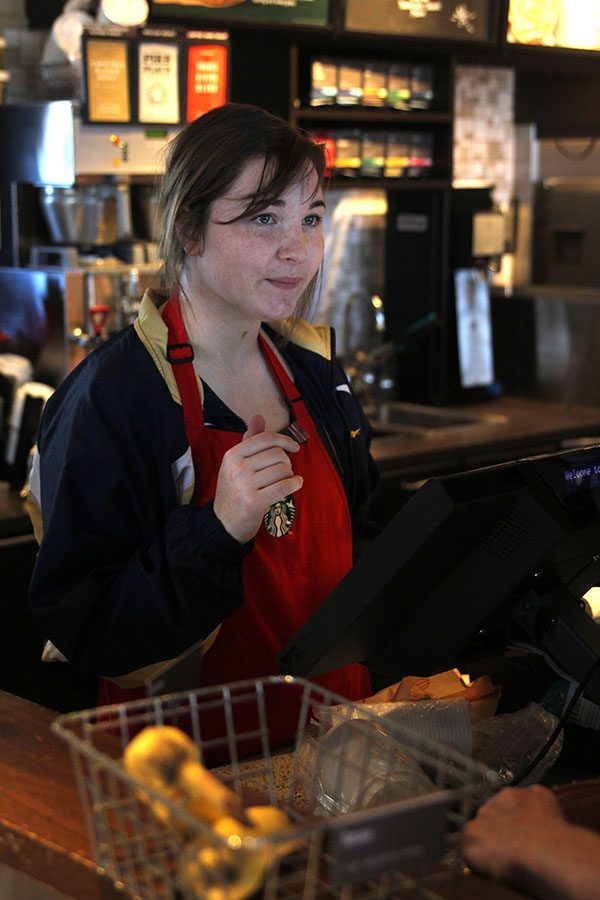 While working on Wednesday, Nov. 22, senior Kiley Beran takes customers orders at the register.