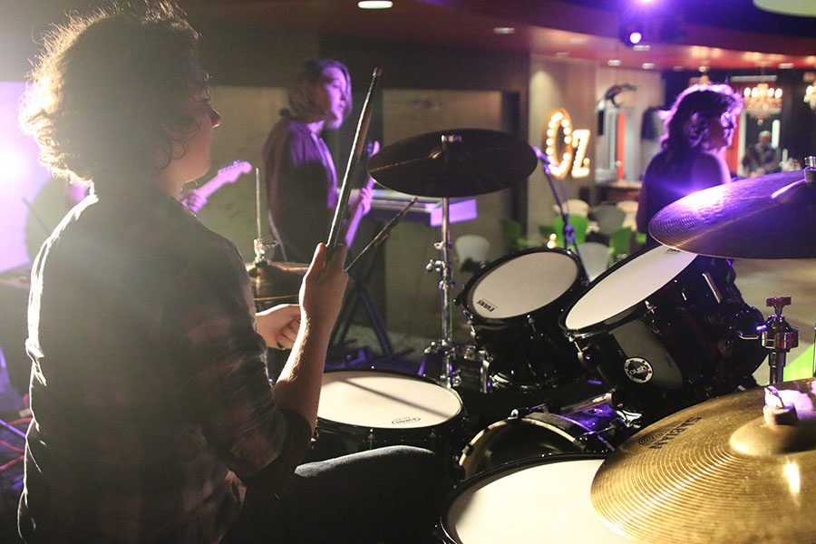 While rehearsing on Monday, Dec. 4, sophomore Cael Duffin plays the drums with his class from School of Rock.  “It’s the interconnectedness that School of Rock has that makes it less of a band and more of a family,” Duffin said.