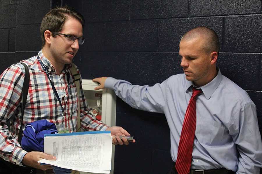 Shawnee Dispatch reporter Chris Duderstadt interviews head boys basketball coach Michael Bennet after a game on Friday Nov.  1.  Duderstadt is one of two full time employees at the Dispatch.