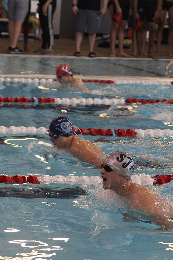 Swimming in the 200 medley relay, sophomore Noah Collins passes the competition at the Lansing Relays swim meet on Saturday Nov. 2.