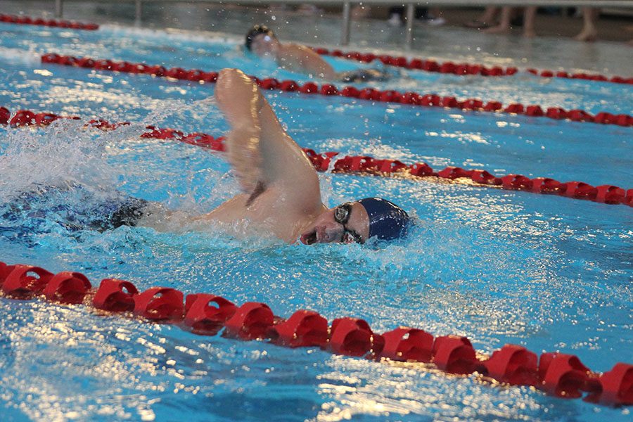 Taking a breath, sophomore Colby Beggs competes in the 200 free relay.