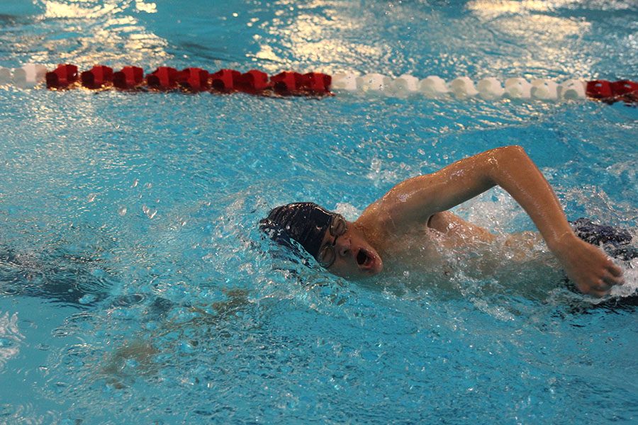 Turning his head for a breath, junior Andrew Thomas swims in 
the 400 free relay at the first meet of the boys swim season on Saturday Dec. 2.  I did the best Ive ever done in swim, so Im pretty proud of that, said Thomas.
