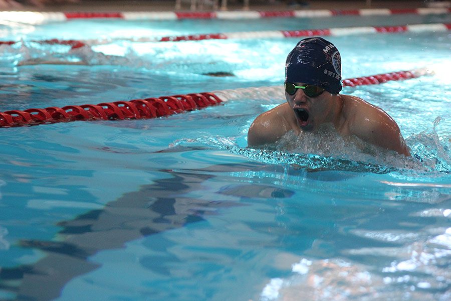 Coming up for a breath, freshman Noah Collins swims breast stroke on Saturday Nov. 2 at the Lansing Relays swim meet.