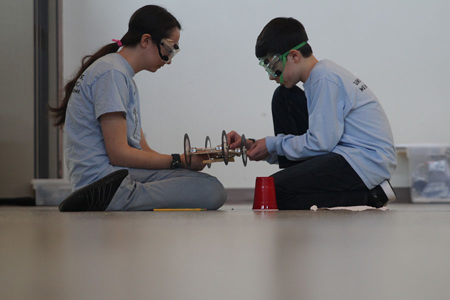 While participating in the Mousetrap Vehicle event, junior Julie Brown and freshman Alex Whipple wind up their car at the ThunderKat Klash on Saturday, Dec. 2.