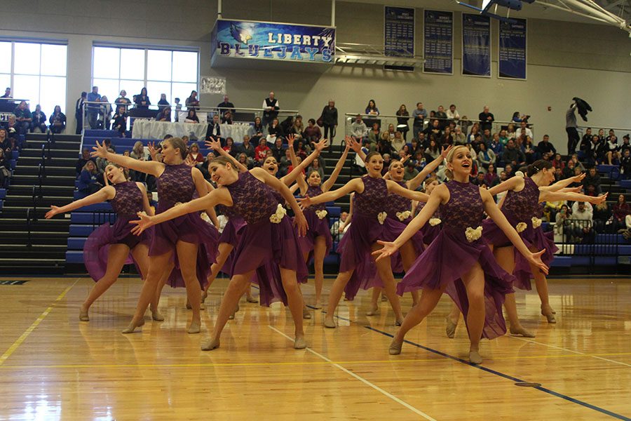 With junior Bella Line leading the pack, dance team members stretch outward. The jazz routine played first in division three and also won a technician award.