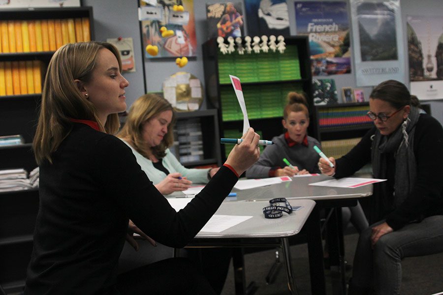 During the English Professional Learning Community meeting on Tuesday, Dec. 6, English teacher Anna Nelson examines and discusses with fellow English teachers the accreditation rubric for the district. // Victoria Wright