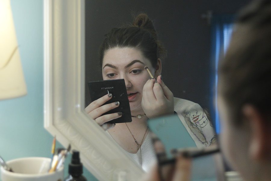 On the afternoon of Thursday, Nov. 30, sophomore Kara Poje sits in front of her vanity to do her make-up. I think it could make some people think about doing some more crazy things like dress differently and do what they want to do, Poje said.