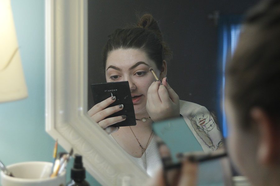 On the afternoon of Thursday, Nov. 30, sophomore Kara Poje sits in front of her vanity to do her make-up. "I think it could make some people think about doing some more crazy things like dress differently and do what they want to do," Poje said.