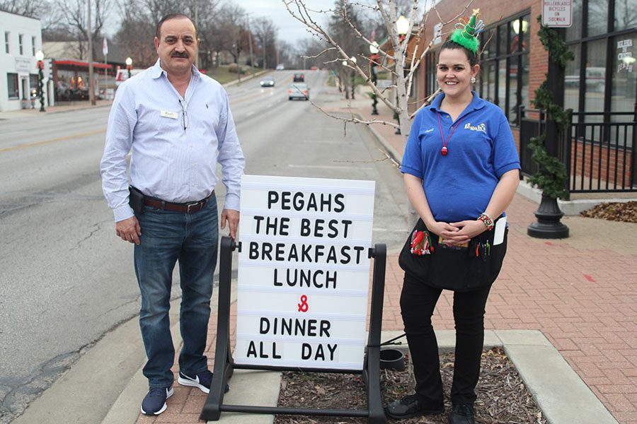 Advertising a family-friendly environment at Pegahs Family Resturant, owner Mo Sharifi and server Jeni Ingle stand on the corner of Johnson Drive and Niemann. People are coming not only because the food is really good, but its also the people you will see when youre here, Ingle said.