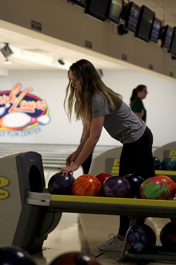 Picking up her bowling ball, senior Emily Jackson gets up for her next turn in the competition.
