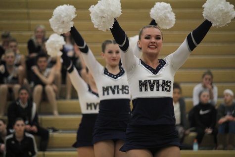 During the pom routine on Saturday, Jan. 13, senior Emmy Bidnick smiles. This routine received a polish and precision award, and was also selected to be performed in the showcase for the first time in school history.