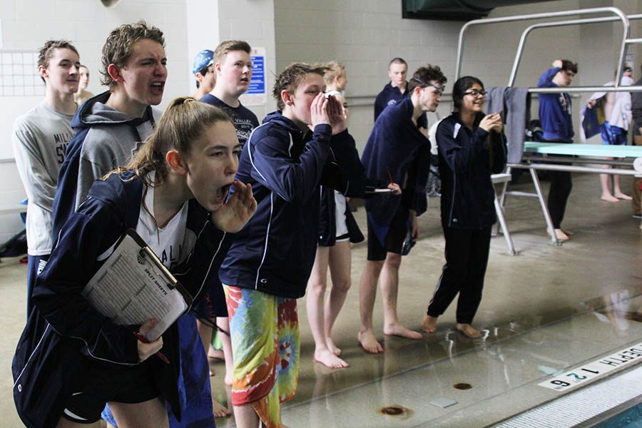 Swim manager Carly Tribble cheers for sophomore Colby Beggs alongside members of the team.