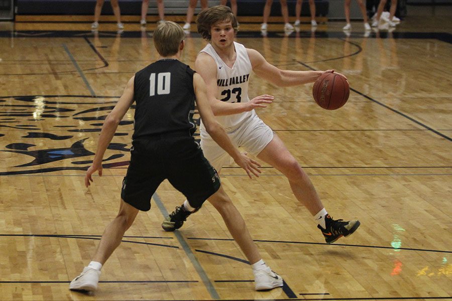 Dribbling around a defender, senior Cooper Kaifes looks to make his way to the basket. The Jaguars beat Blue Valley Southwest 67-41 on Tuesday, Jan. 30.