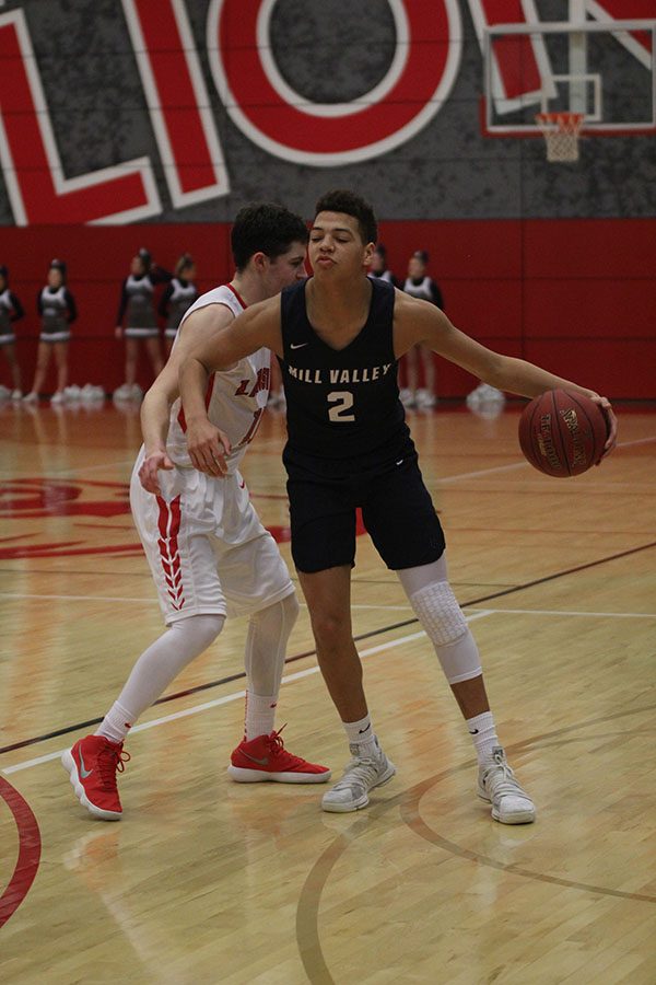 Junior Matt Wittenauer dribbles the ball past a Lansing defender.