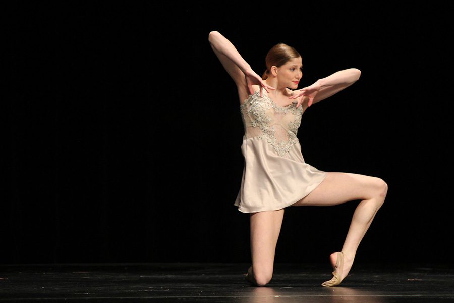 Pointing her toe, junior Addie Ward finishes up her solo on Friday, Jan. 12.