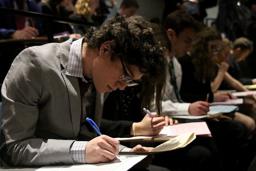 Looking at the test, senior Daniel Nicot competes in the Blue Valley High School Invitational DECA meet on Wednesday, Jan. 31. 