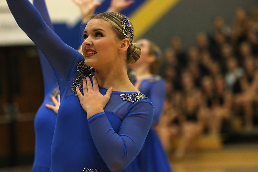 Looking above, senior Emmy Bidnick performs her part in the jazz routine on Saturday, Jan. 13.