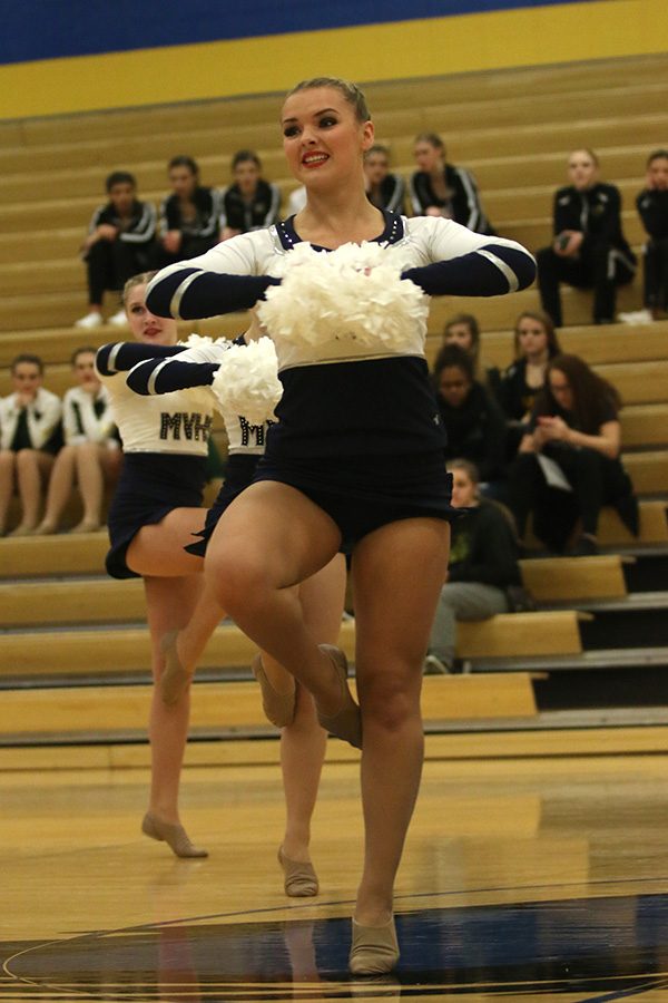 Performing the pom routine, senior Emmy Bidnick prepares to turn.