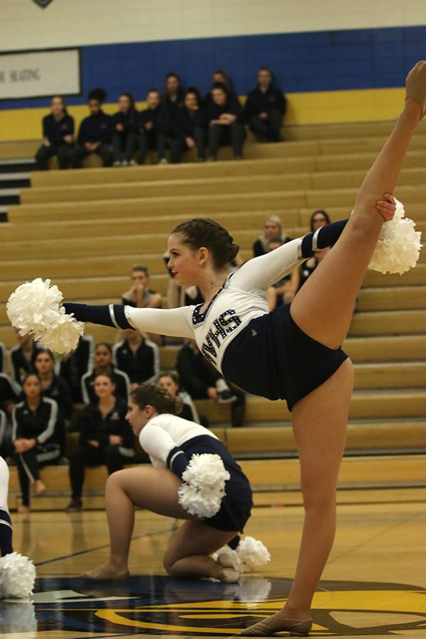 With her leg outstretched, freshman Tyler Bret does her part during the pom routine on Saturday, Jan. 13.