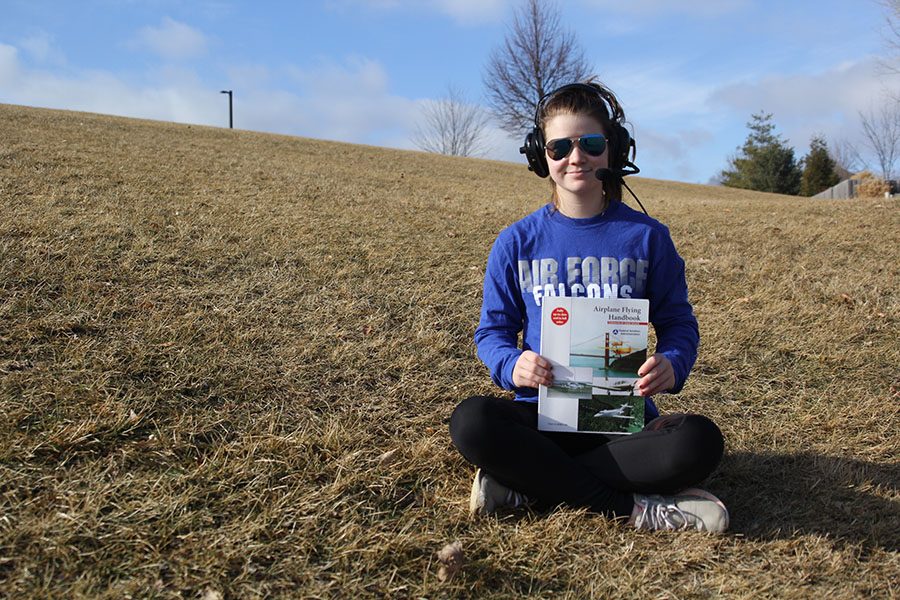 After years of flying experience, freshman Belle Bonn proudly displays her flying handbook, on Tuesday, Jan. 23.