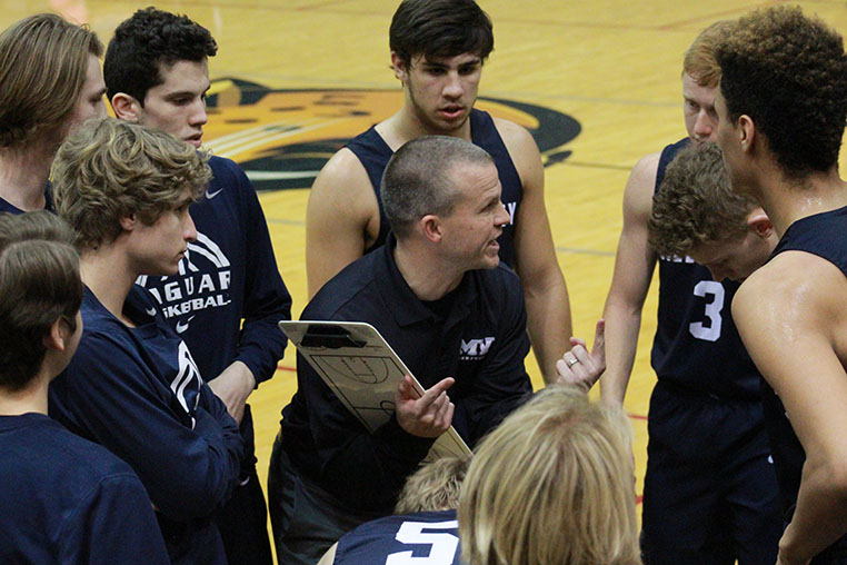 Head coach Michael Bennett strategizes to make a comeback during a 30 second timeout at the end of the game on Friday, Jan. 12.