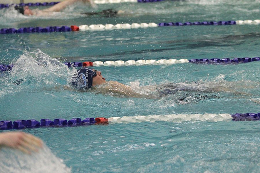 While completing the second lap of the 200 yard individual medley, sophomore Avery Lawson swims backstroke on Wednesday, Jan. 17 at Chisholm Trail Middle School.