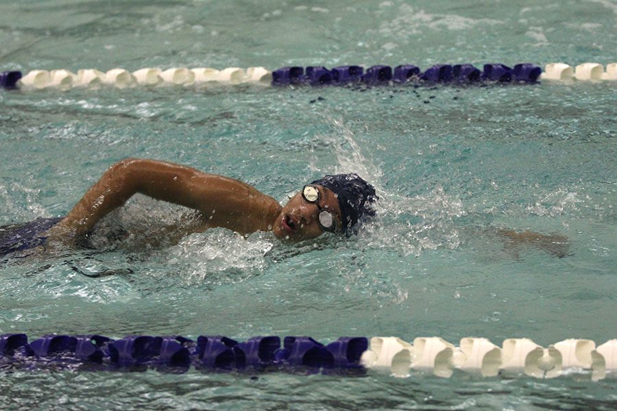 Sprinting through the 50 freestyle, freshman Romann Oertle turns to take a breath.