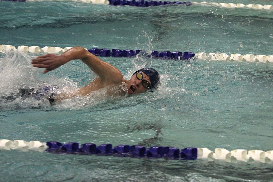 Sprinting to the end of the pool, sophomore Avery Lawson swims his leg of the 400 yard freestyle relay.