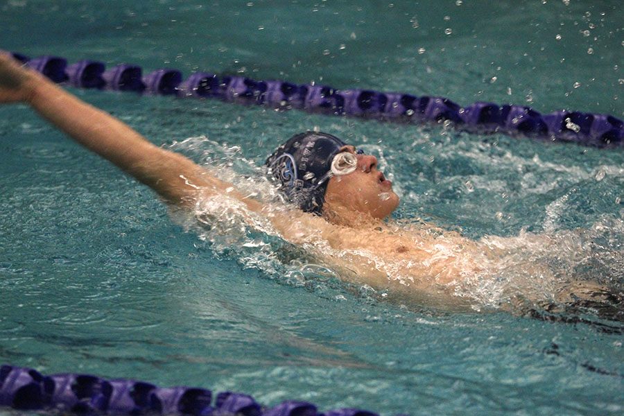 Swimming in the 100 yard back stroke, freshman Noah Collins competes at Chisholm Trail Middle School on Wednesday, Jan. 17.