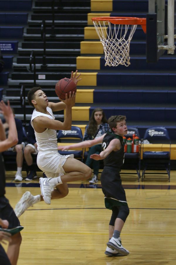 After a steal on the defesive end, junior Matt Wittenauer shoots a layup.