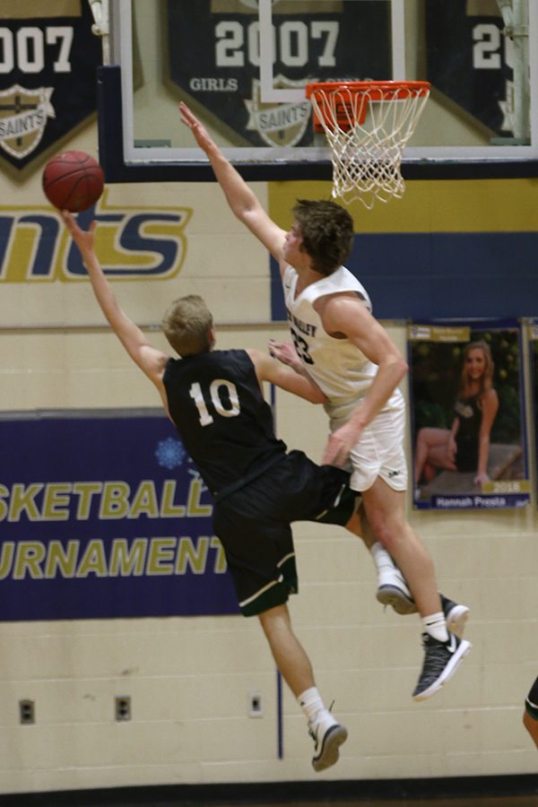 Jumping above his defender, senior Cooper Kaifes attempts to block a shot.
